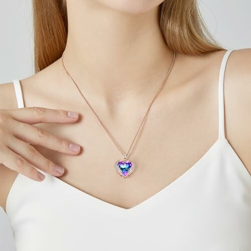 Woman wearing heart-shaped rainbow pendant necklace